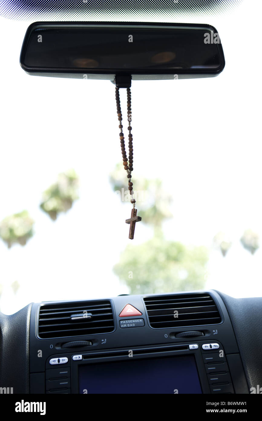 Rosary hanging from rear view mirror of car Stock Photo Alamy