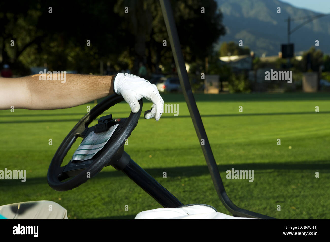 Golfer on golf cart Stock Photo Alamy