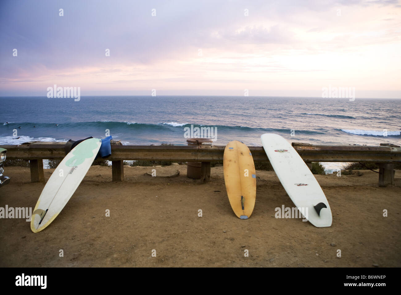 surfboards sit on railing at beach in Malibu Stock Photo Alamy