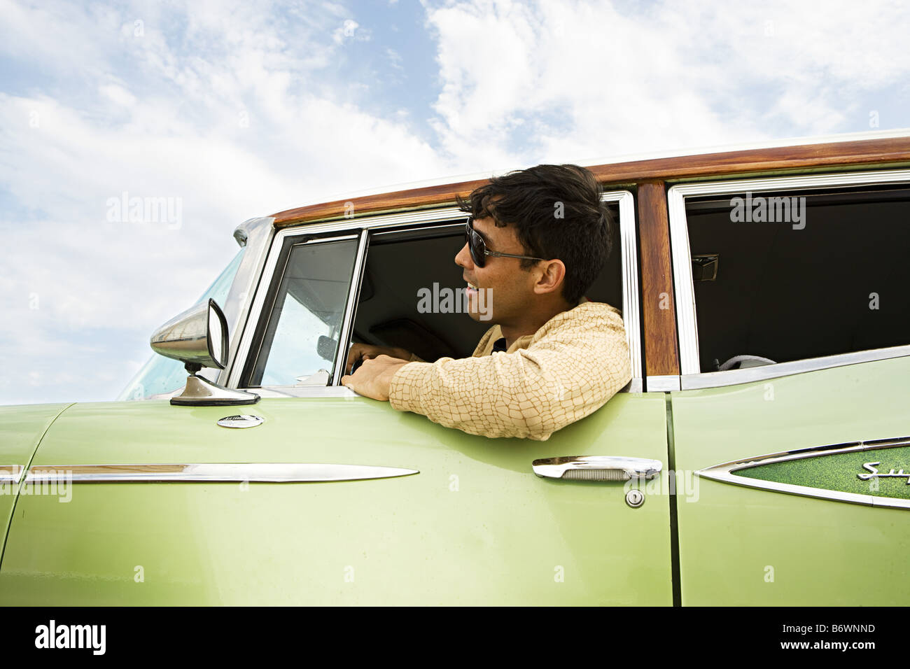 man looks out of window of vintage car in glasses Stock Photo - Alamy