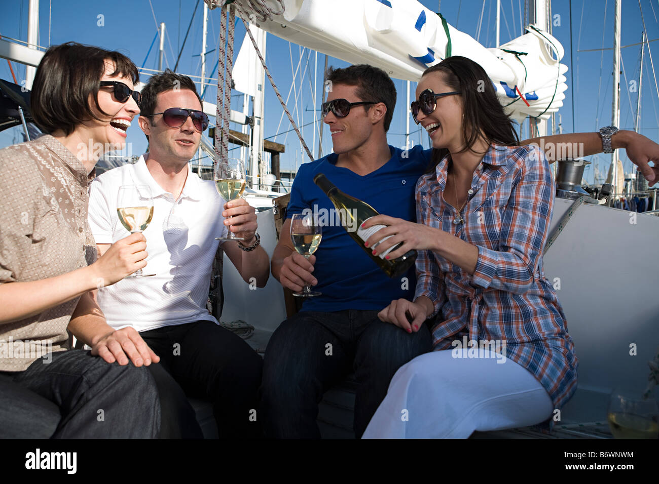 Friends drinking wine on a boat Stock Photo