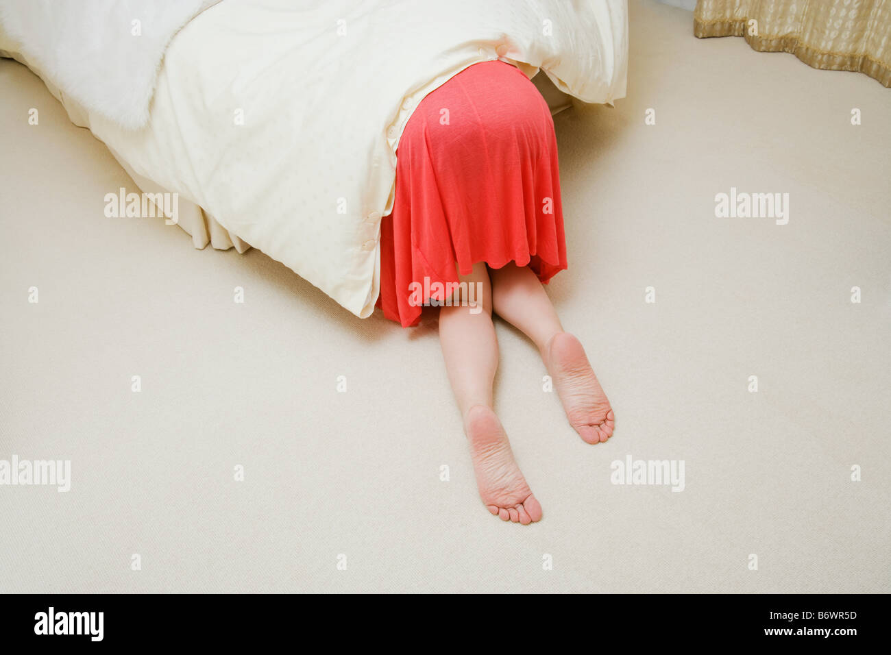 Woman under bed Stock Photo Alamy