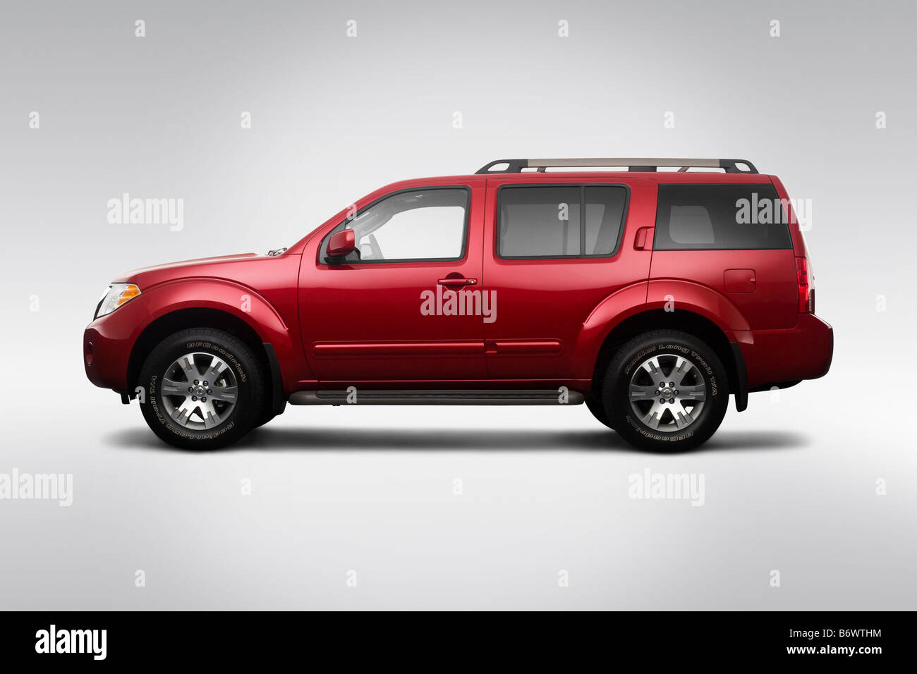 2009 Nissan Pathfinder SE in Red - Drivers Side Profile Stock Photo