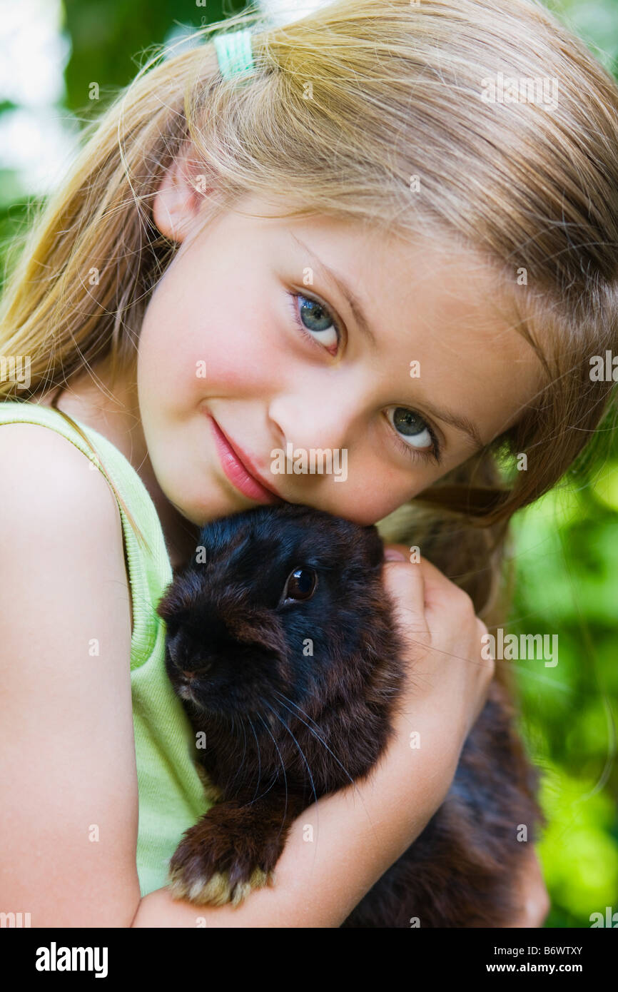 Portrait of a girl holding a rabbit Stock Photo