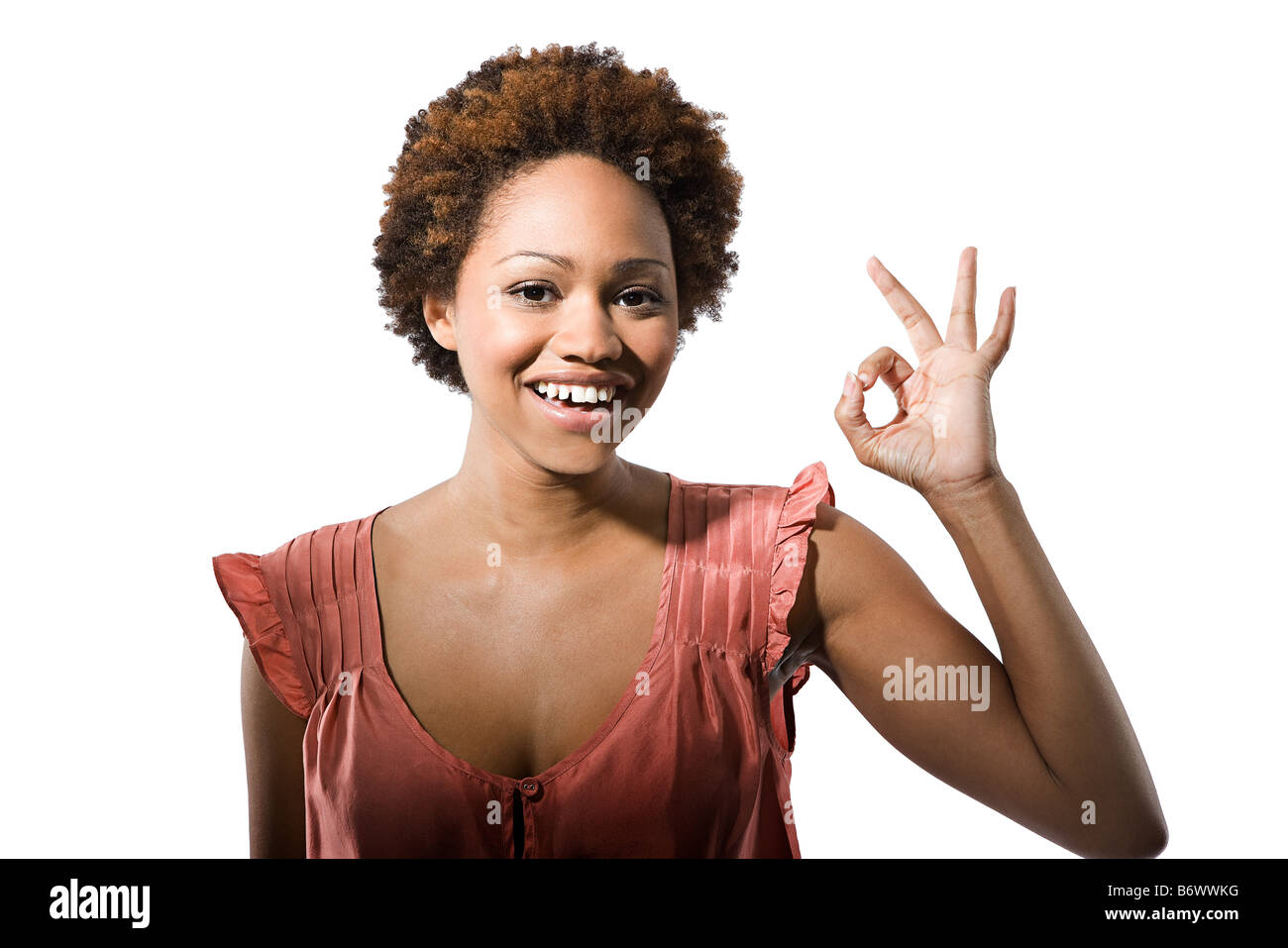 Portrait of young woman giving the ok sign Stock Photo