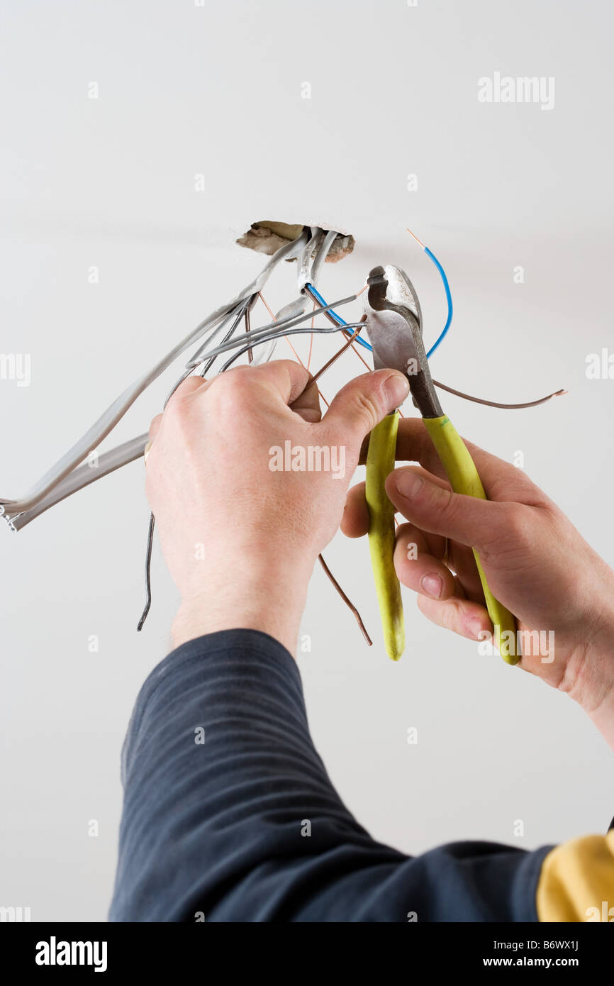 An electrician cutting wires Stock Photo - Alamy