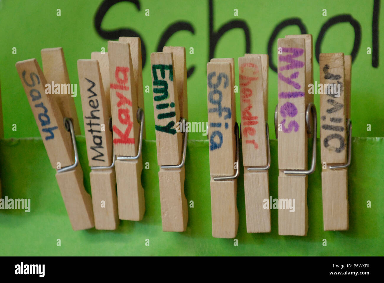 Close-up of pegs in classroom with children's names Stock Photo