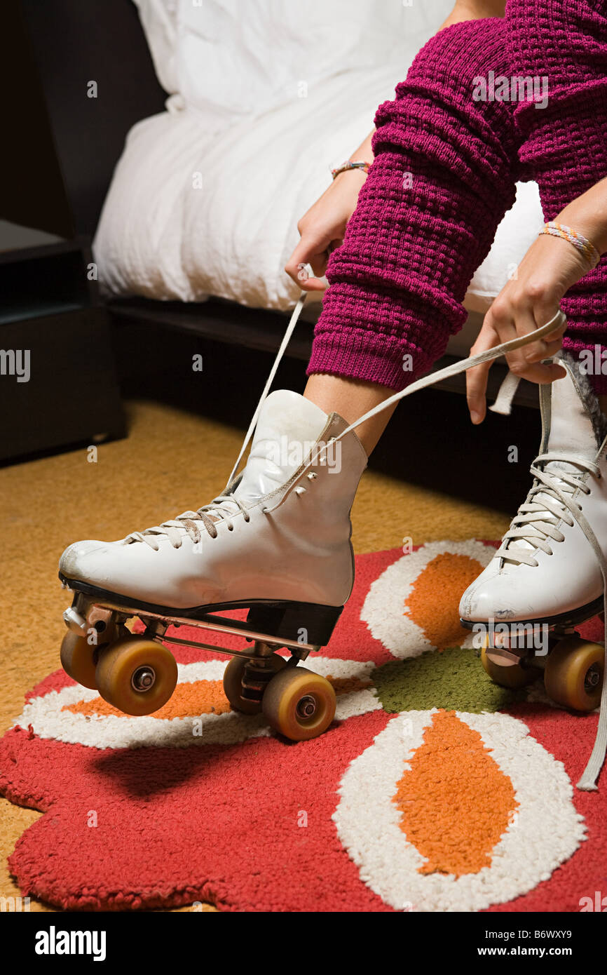 Girl putting on roller skates Stock Photo
