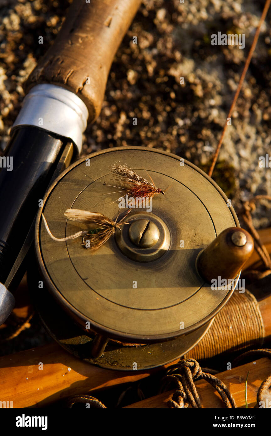 UK, Wales, Conwy. A traditional brass fishing reel fitted to a split-cane fly rod with trout fishing flies Stock Photo