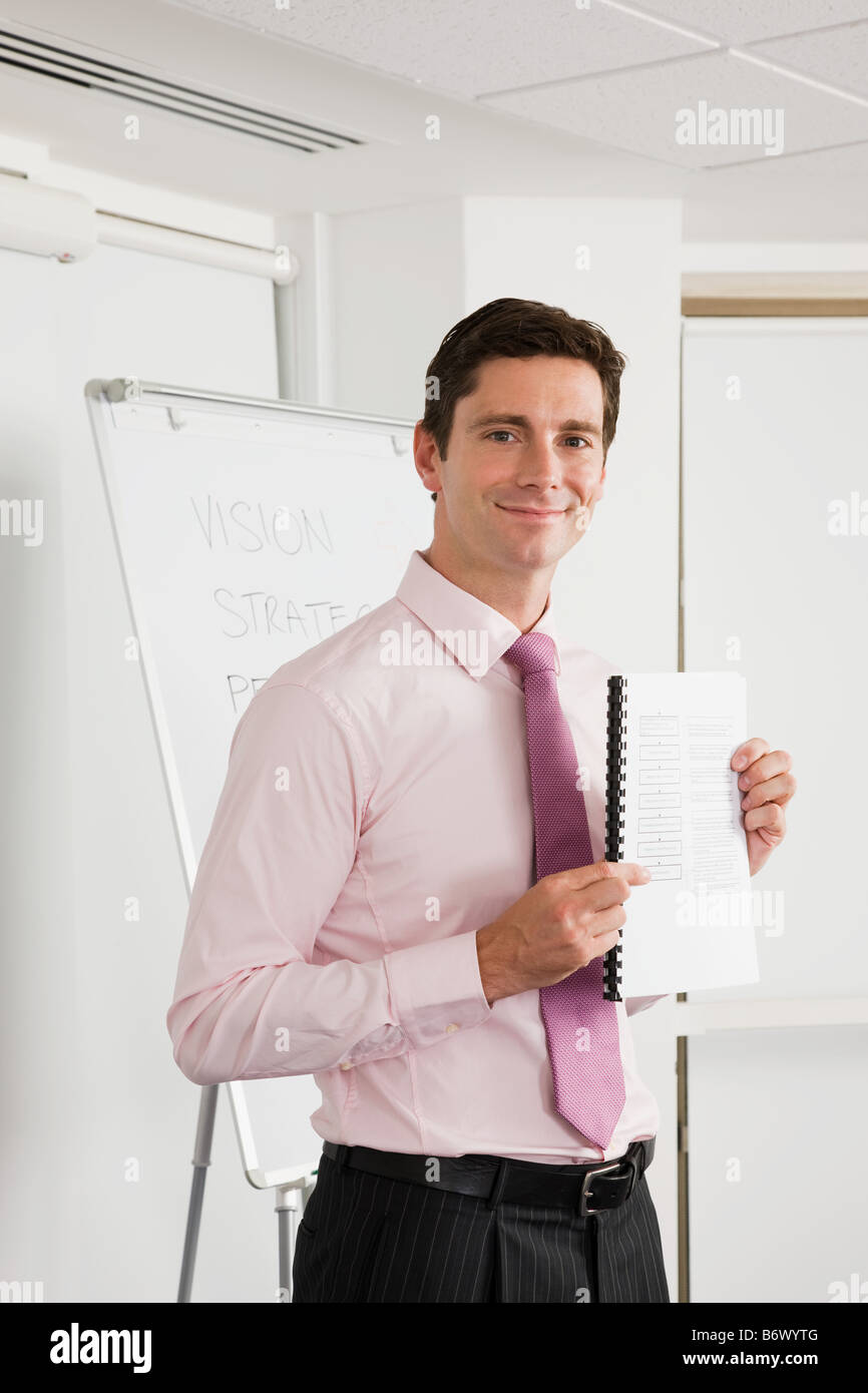 A lecturer holding a textbook Stock Photo