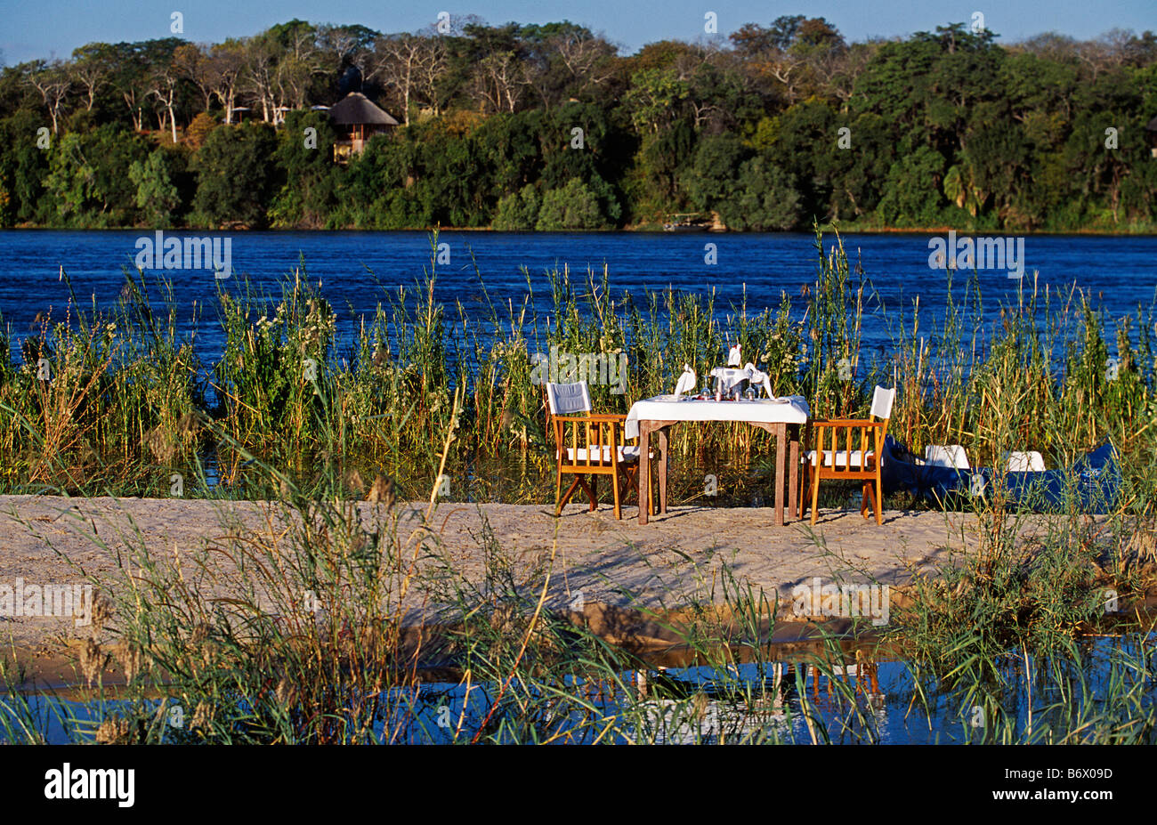 Zambia, Livingstone. The River Club - honeymoon lunch set up on island in the Zambezi River in front of the lodge. Stock Photo
