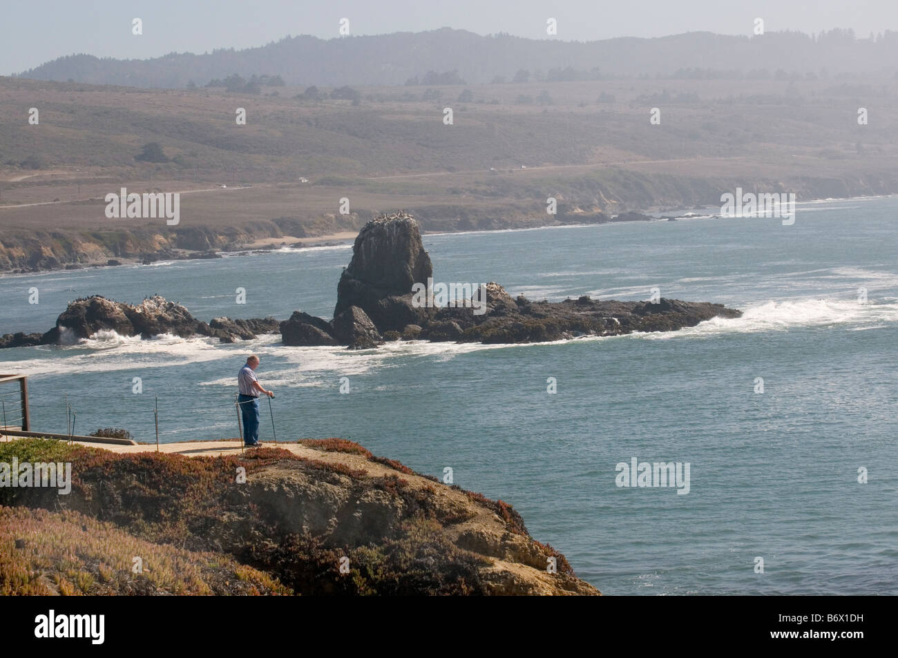 Man on overlook in Big Sur on Pacific coast highway Stock Photo