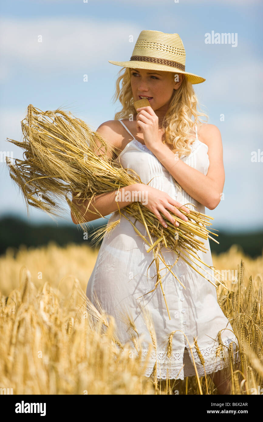 Young woman in a wheat field Stock Photo - Alamy