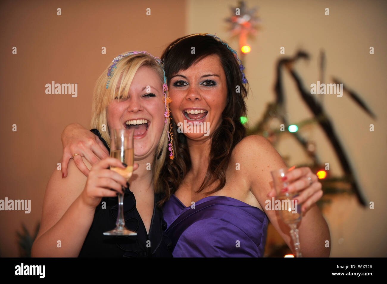 Party girls drinking sparkling wine getting drunk on a night out Stock Photo