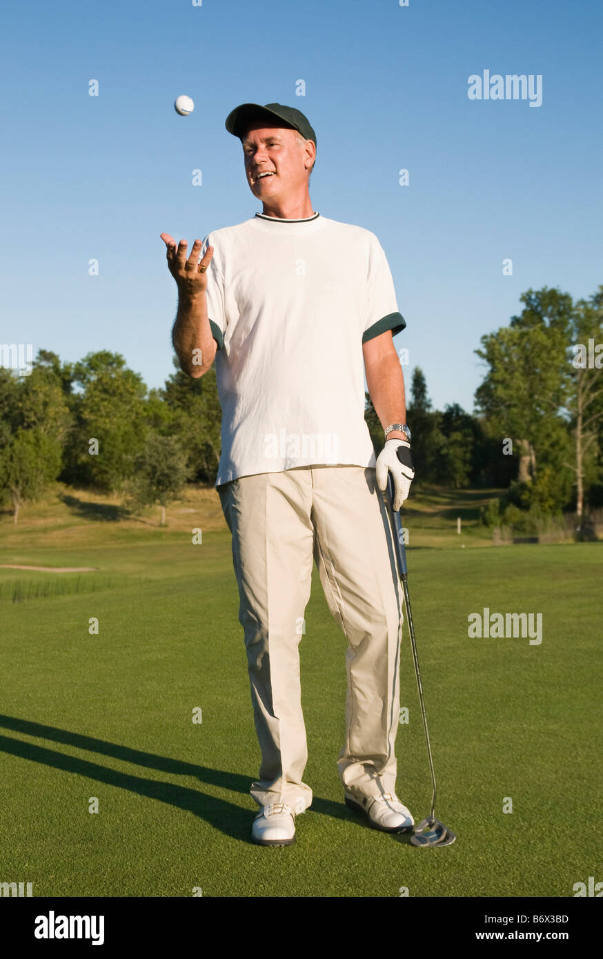 Man with golfball Stock Photo