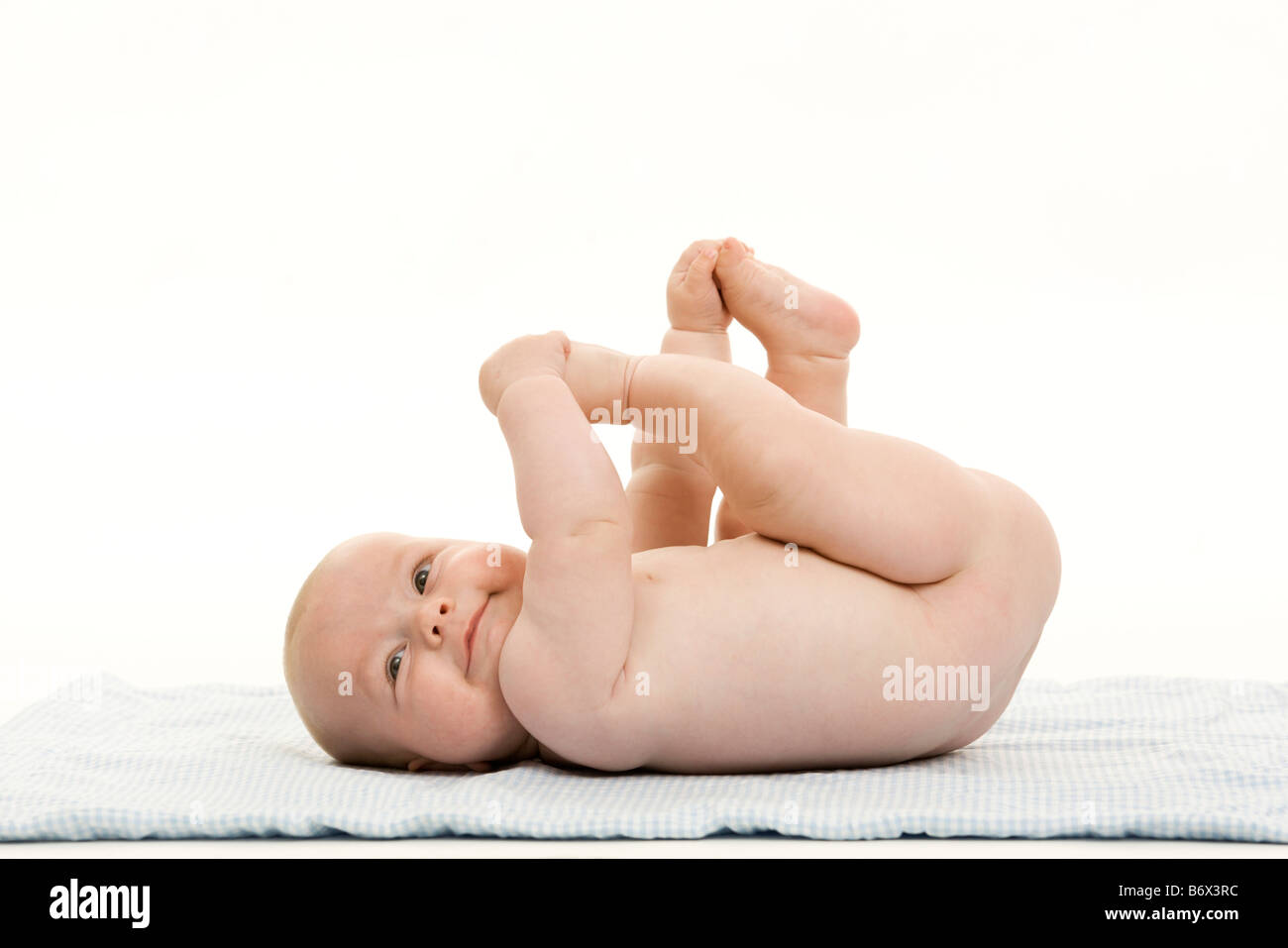 a baby laying on a blanket Stock Photo
