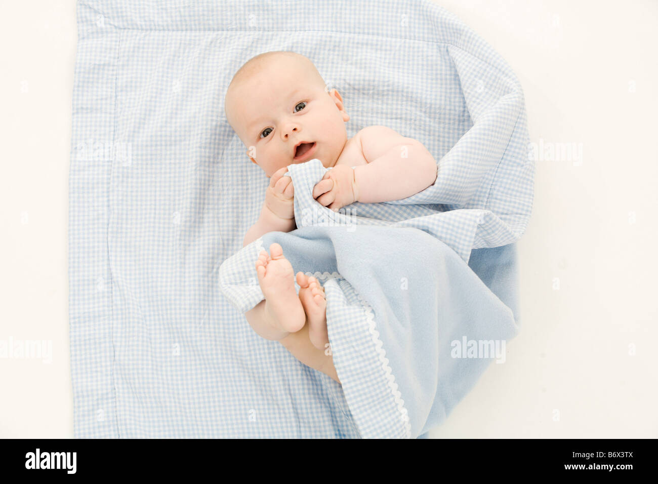 GER Germany North Rhine Westphalia Cologne 2008 11 24 a baby laying on a blue blanket Stock Photo