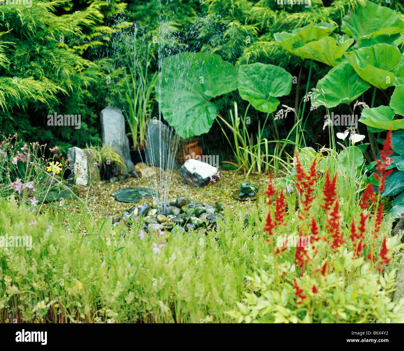 PEBBLE FOUNTAIN IN GRAVELLED AREA OF FLOWER BED Stock Photo Alamy