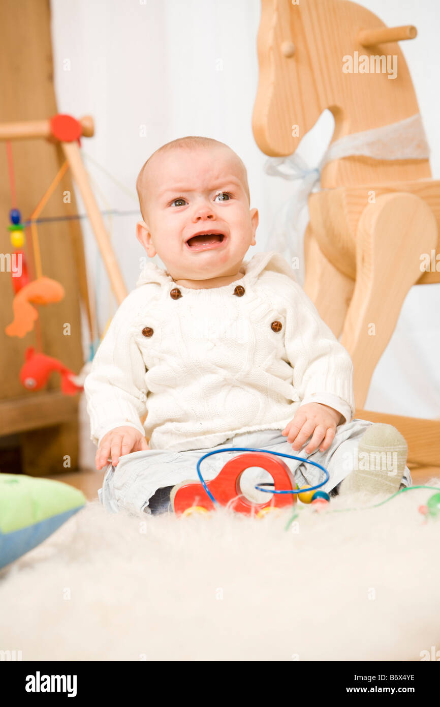 a baby is playing with toys Stock Photo