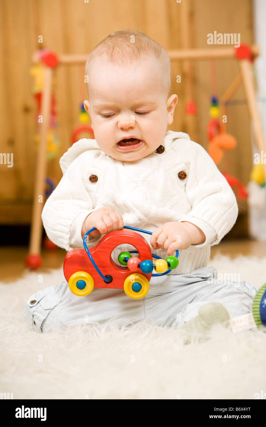 a baby is playing with toys Stock Photo