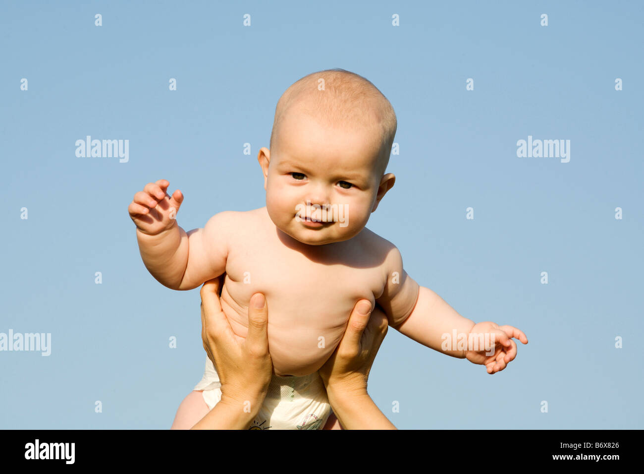 a nacked baby in front of the blue sky Stock Photo