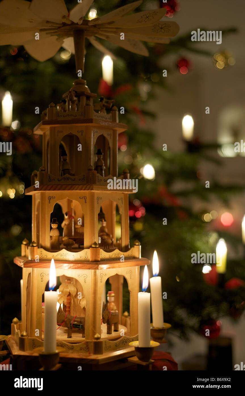 Christmas Pyramid in front of Christmas Tree Stock Photo Alamy