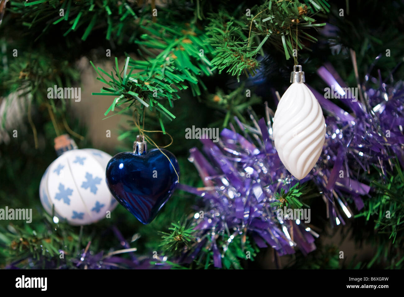 Paper and metallic christmas tree bauble decorations with tinsel Stock Photo