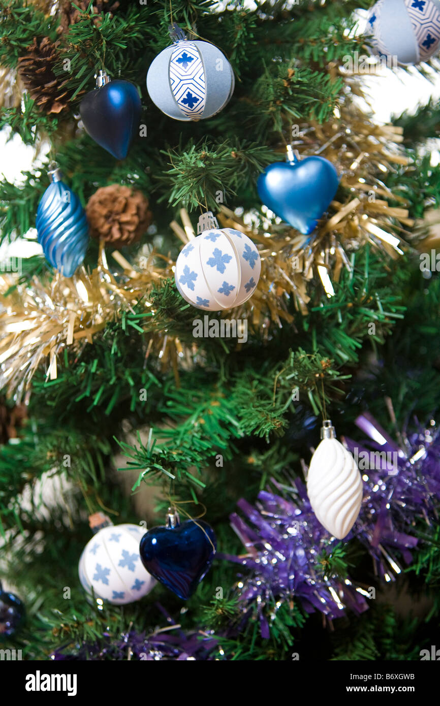 Christmas decorations, paper and metallic with tinsel, on Christmas tree Stock Photo