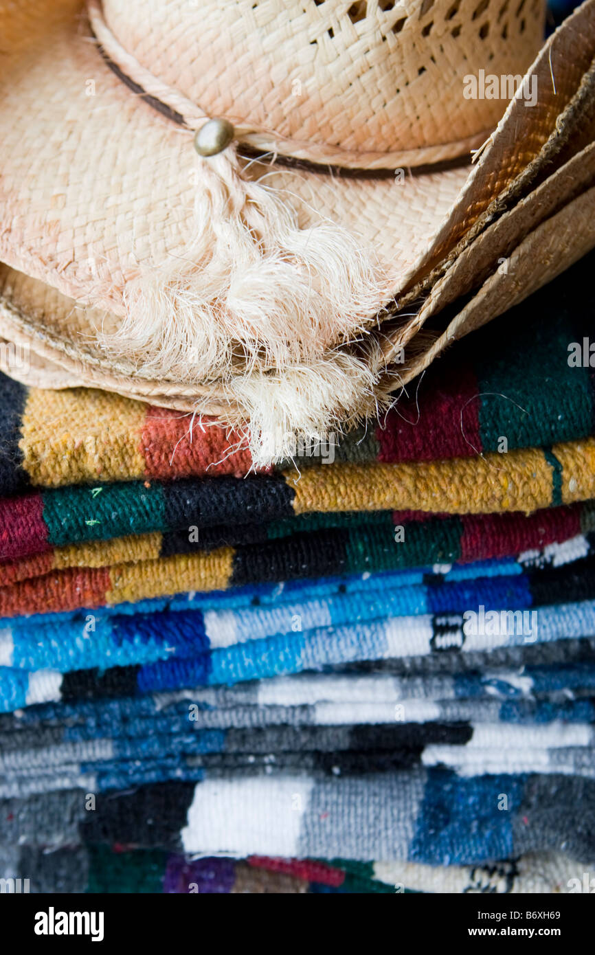 Close up shot of Mexican blankets and a straw hat in a shop in Mexico