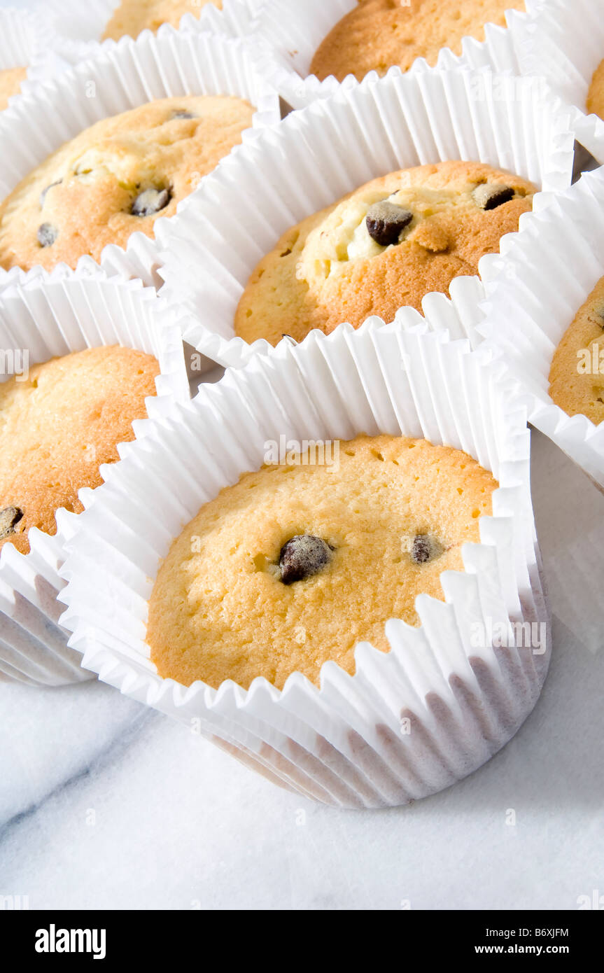 Cooked cupcakes placed on white marble surface to cool down. The recipe