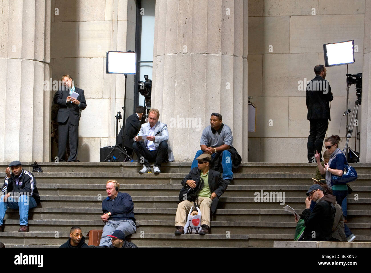 News reporters on the steps of Federal Hall located at 26 Wall Street in New York City New York USA Stock Photo