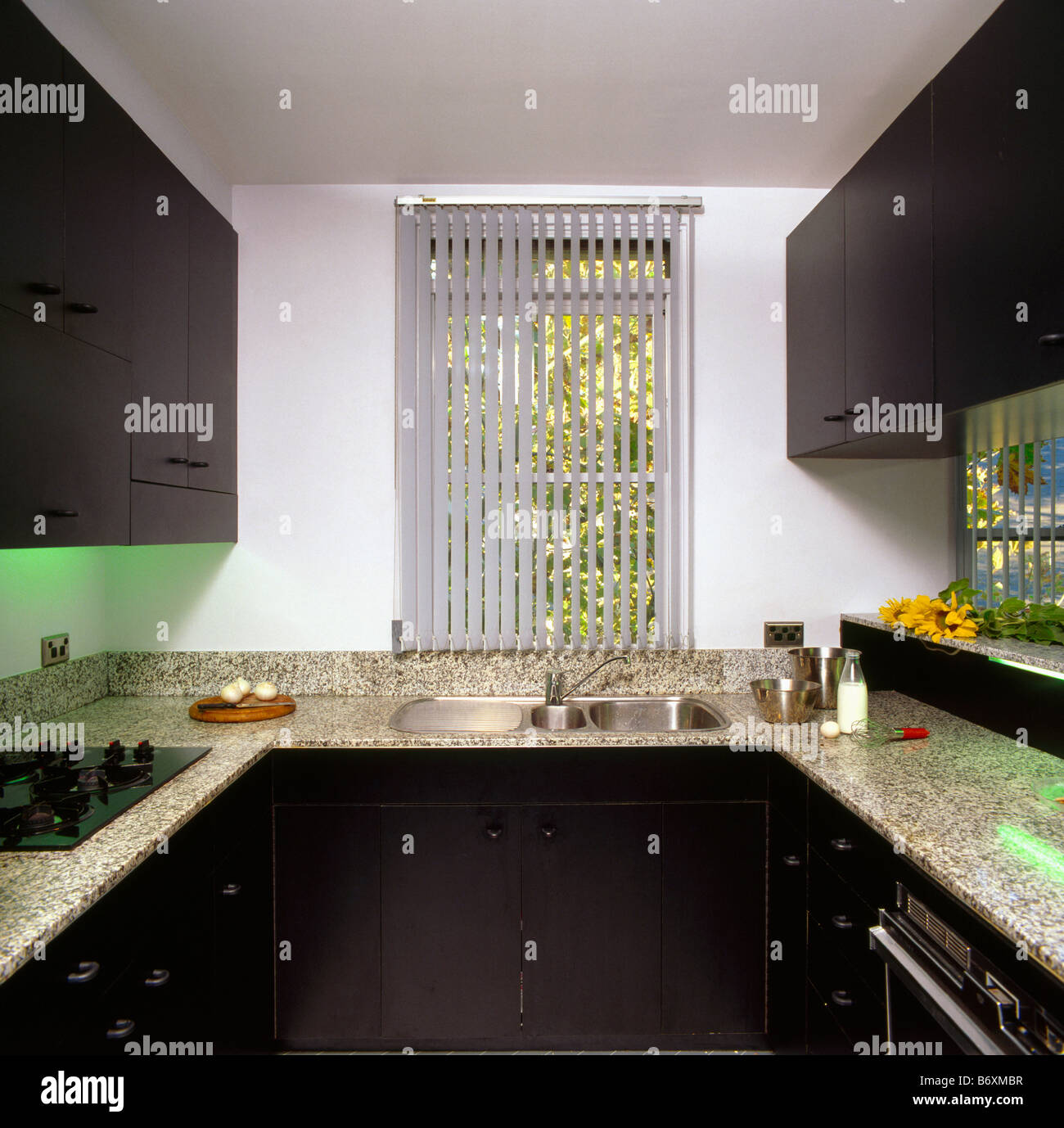 White kitchen units with black worktop hi res stock photography
