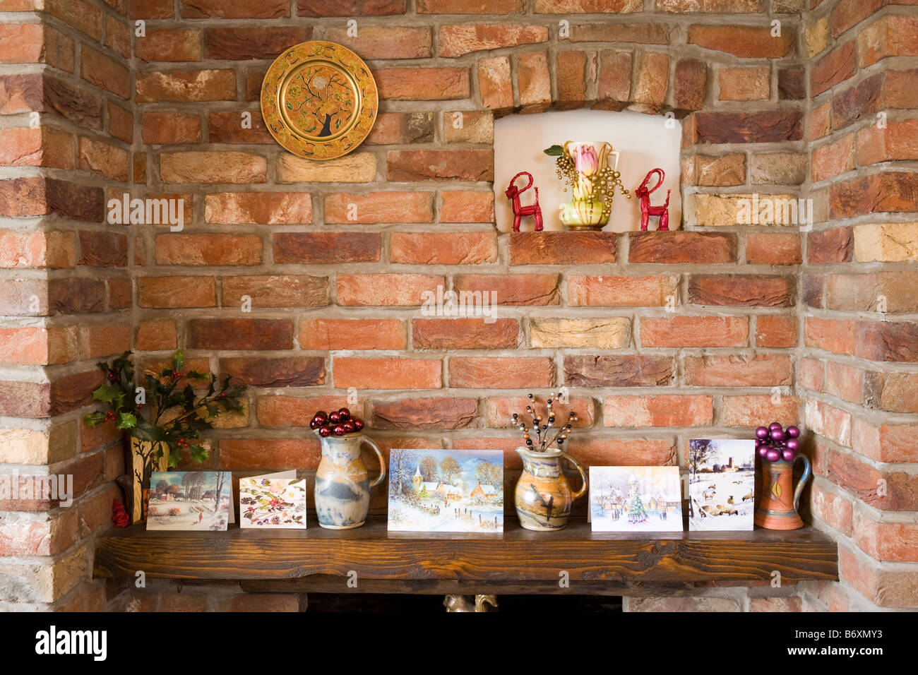 Christmas cards arranged on a mantelpiece in country home UK Stock Photo