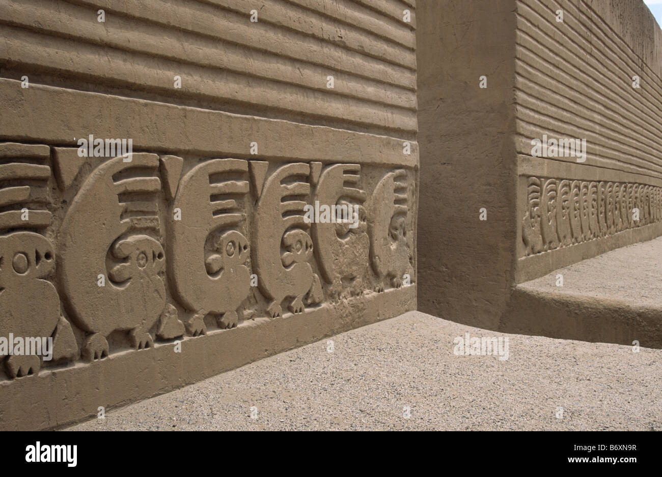 Detail of adobe frieze of sea otter figures in main plaza of Tschudi Palace, Chan Chan, near Trujillo, Peru Stock Photo