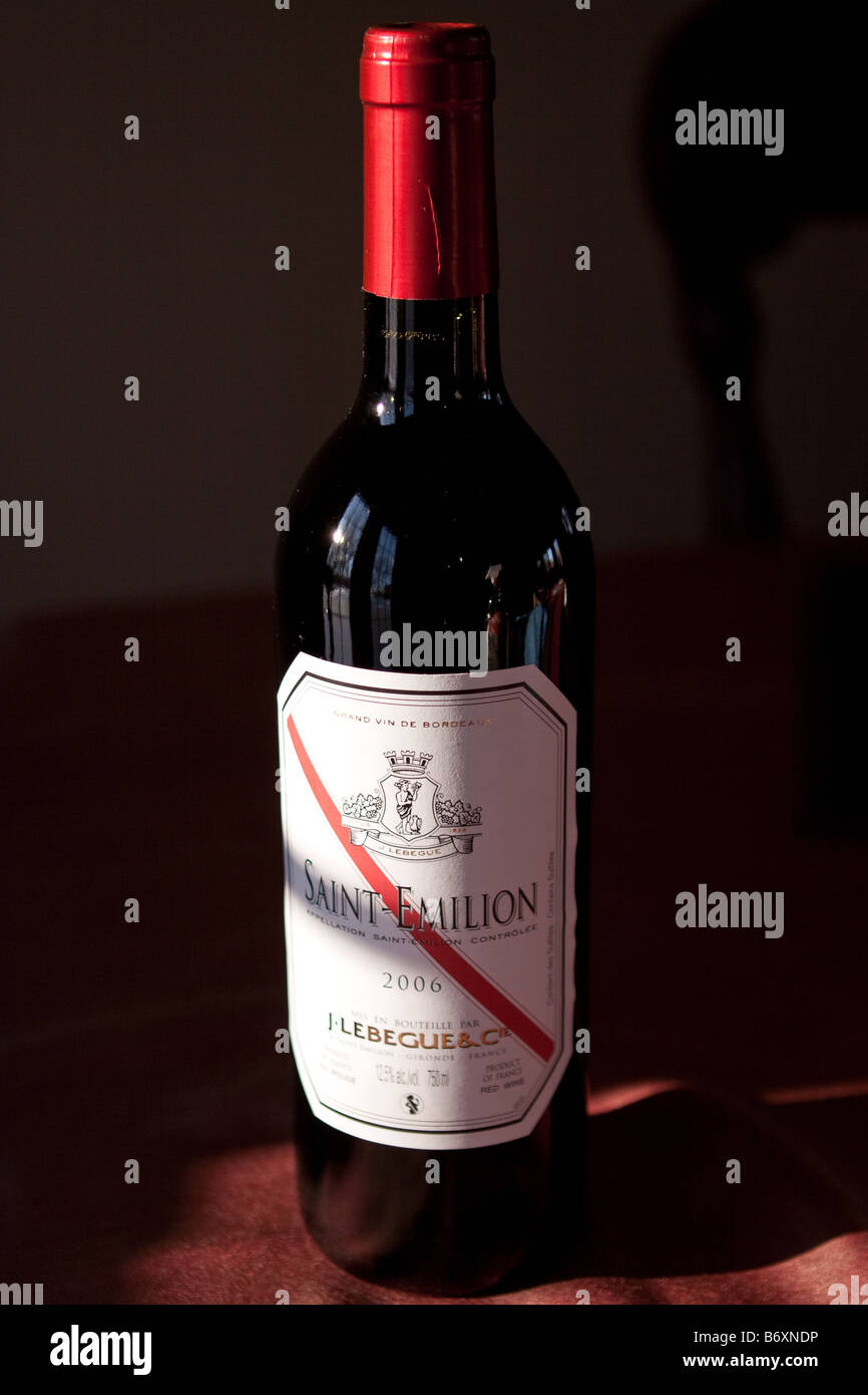 Bottle of red wine in dark setting Stock Photo Alamy