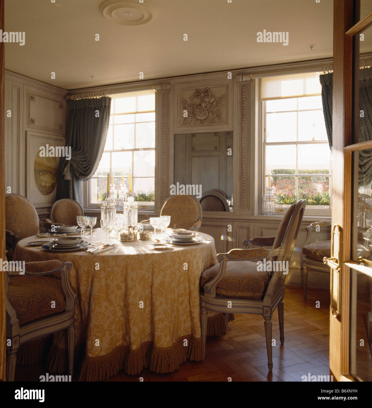 Louis IV style upholstered chairs and table with cream silk cloth in