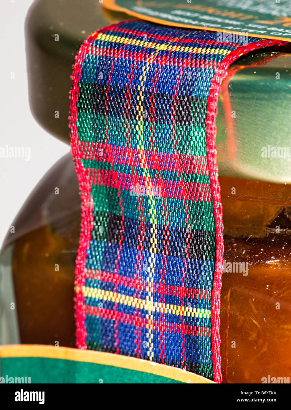 Use of tartan ribbon as selling point on sealed jar of preserves Scotland UK Stock Photo