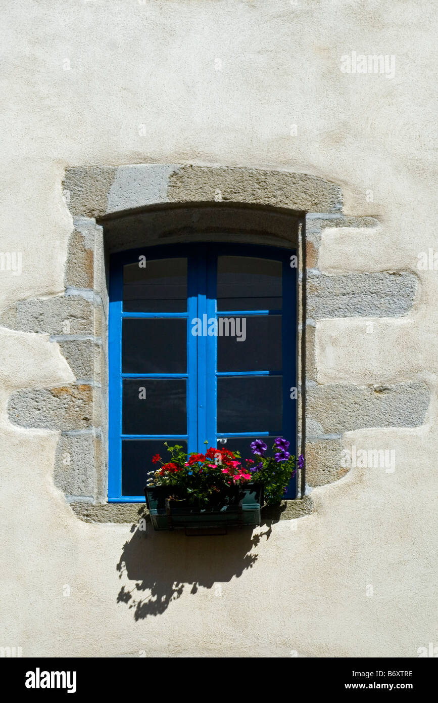 Traditional French windows with window box and flowers Stock Photo