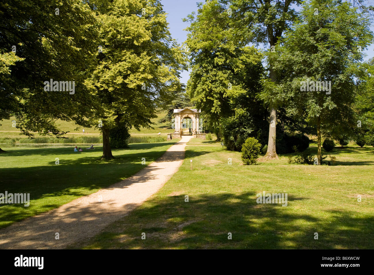 A path leading to a bridge with trees either side Stock Photo - Alamy