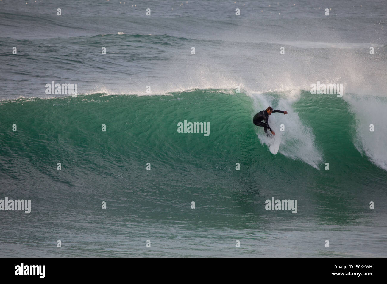 Surfer dropping a wave at Guincho beach, Portugal Stock Photo