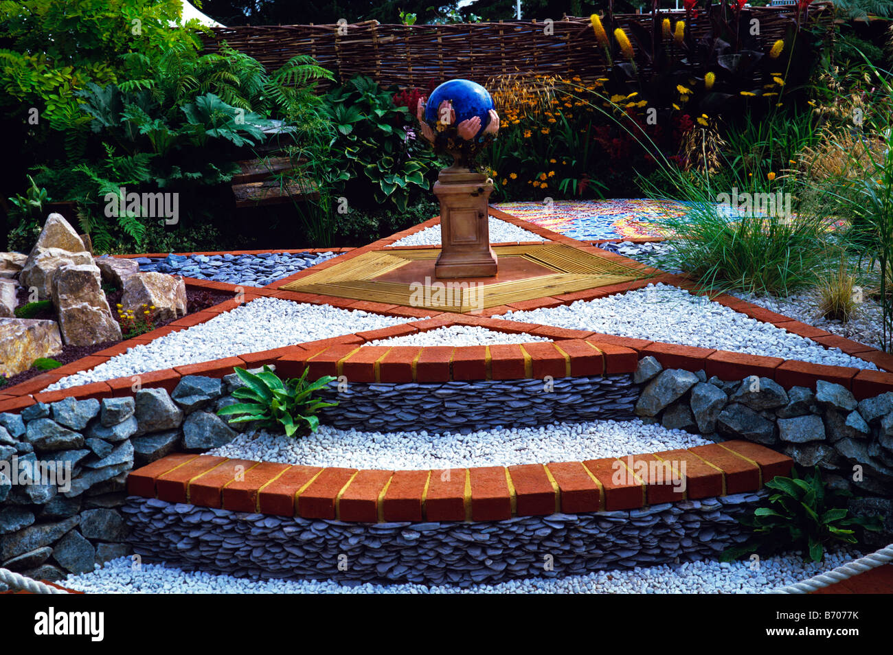 Show garden with star shaped terrace and globe sculpture Stock Photo
