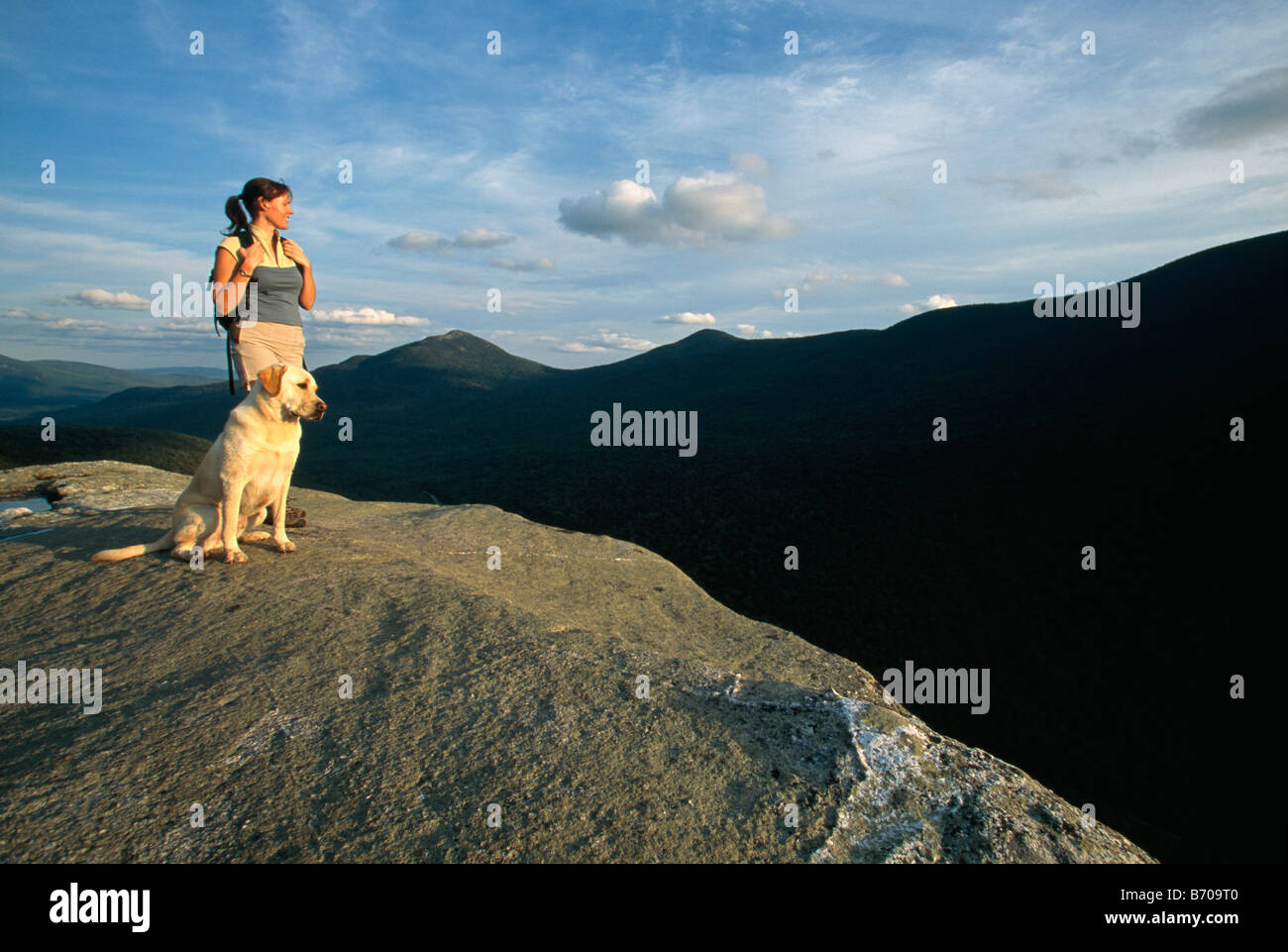 A woman and a dog on a mountain top, Newry, Maine. Stock Photo
