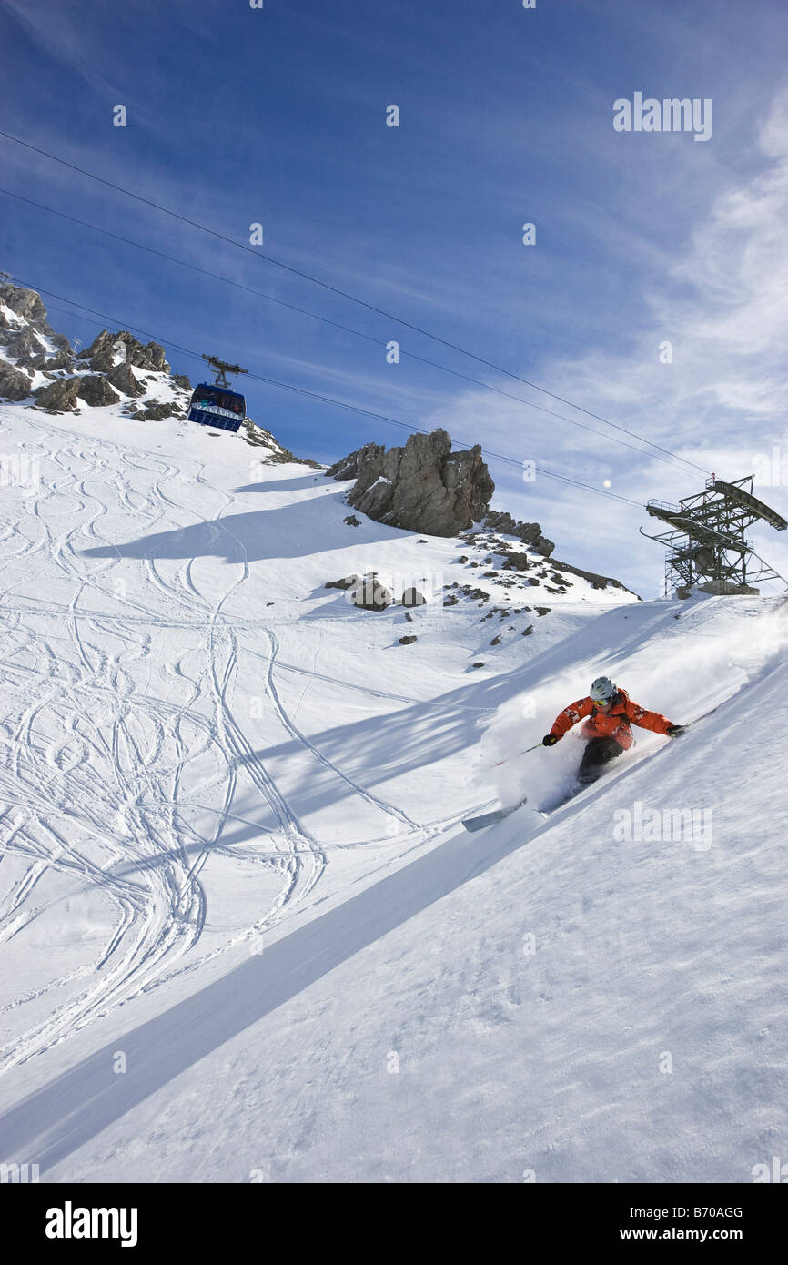A young man skis untracked powder offpiste at St. Anton am Arlberg
