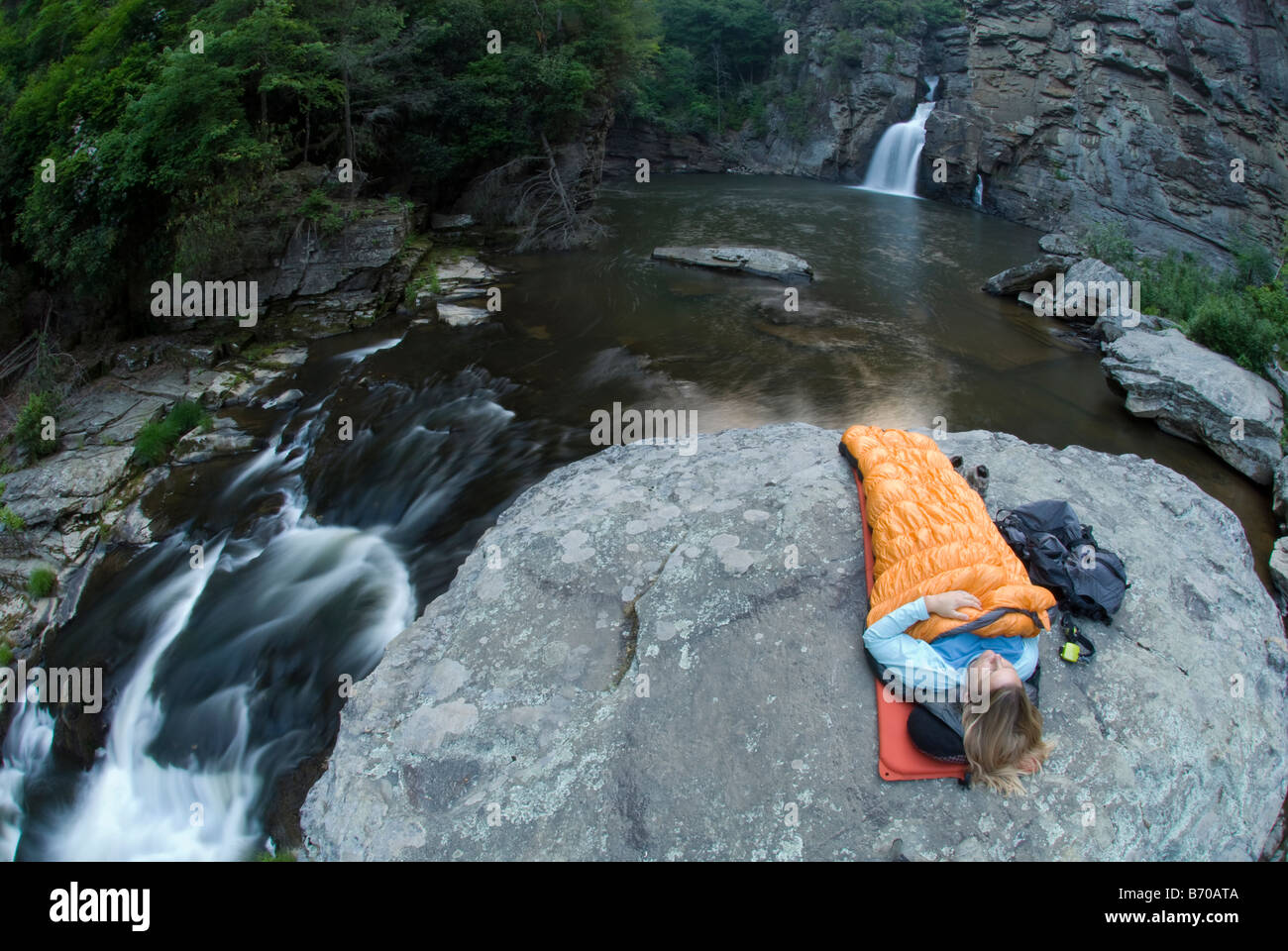 Woman camping on rock below Linville Falls, North Carolina Stock Photo