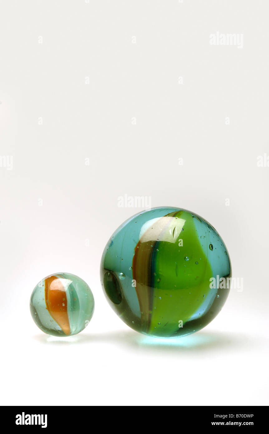 One large and one small marble on white background Stock Photo Alamy