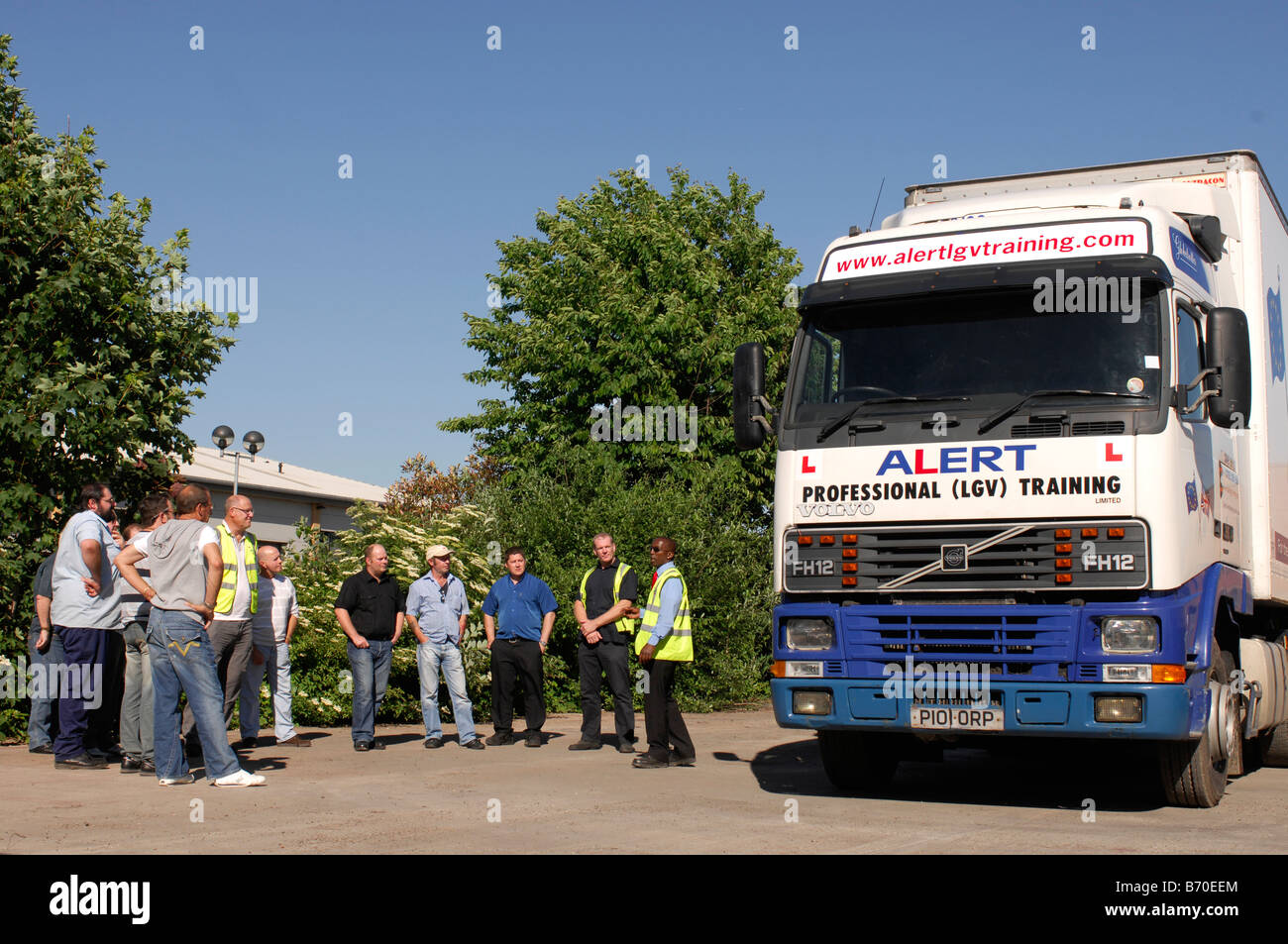 Professional HGV driver training instructor showing trainees around an HGV for daily checks and safety points Stock Photo