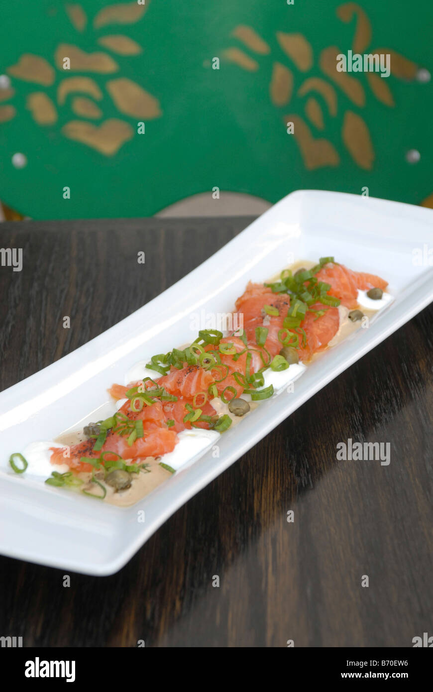 Smoked salmon garnished with spring onions Stock Photo