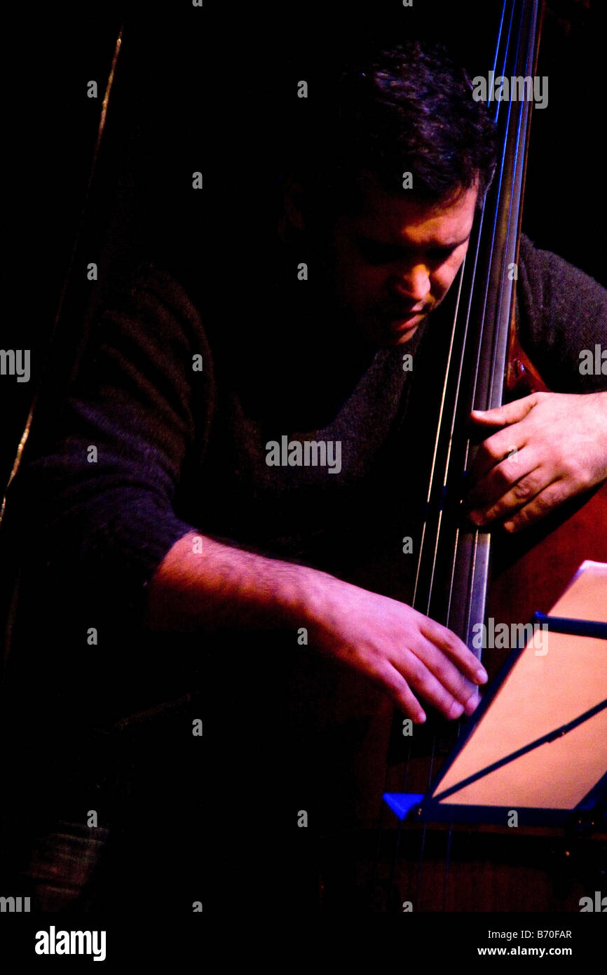 Jazz bass player on stage in dramatic lighting Stock Photo