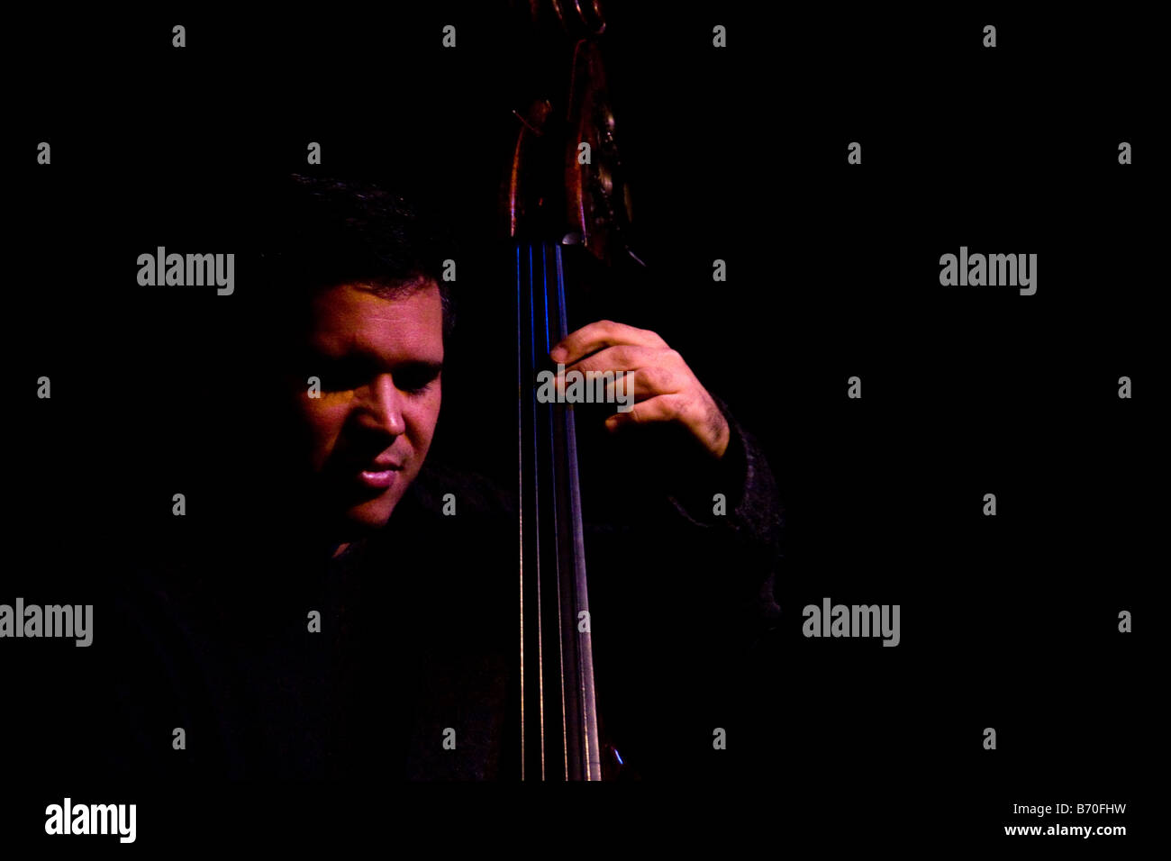 Jazz bass player on stage dramatic lighting Stock Photo