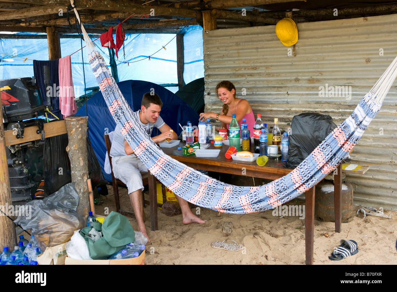 Suriname, Matapica National Park. Tourists having lunch at lodge on the beach. Stock Photo